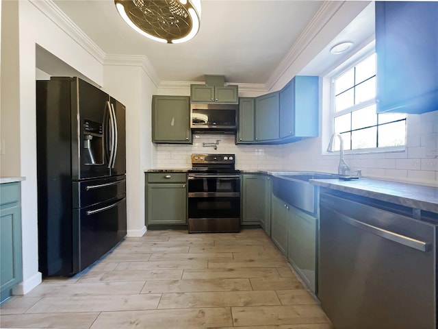 kitchen featuring range hood, sink, backsplash, ornamental molding, and stainless steel appliances