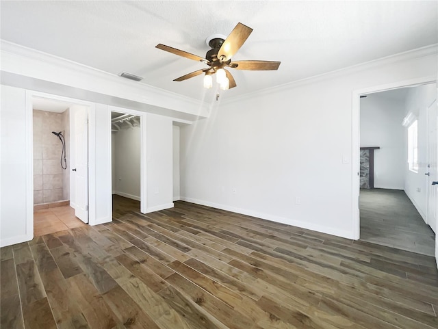 unfurnished bedroom featuring ceiling fan, ornamental molding, dark hardwood / wood-style floors, and ensuite bathroom