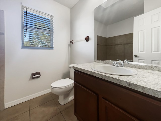 bathroom with vanity, tile patterned floors, and toilet