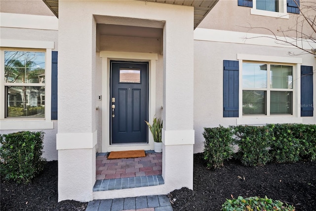 property entrance with stucco siding