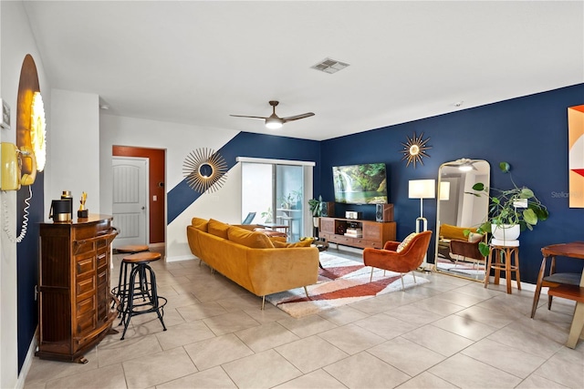 living room featuring light tile patterned flooring and ceiling fan