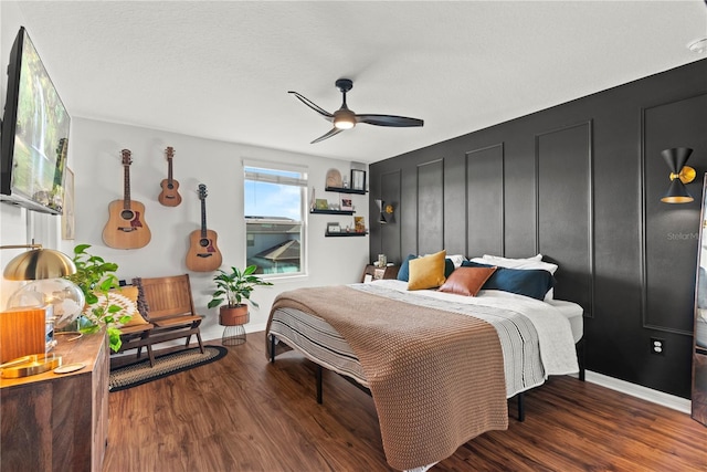 bedroom with dark hardwood / wood-style floors and ceiling fan