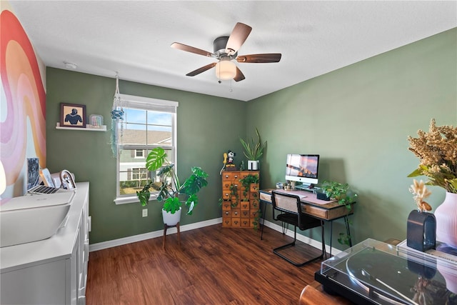 office with a ceiling fan, baseboards, and dark wood-style flooring