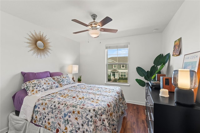 bedroom featuring a ceiling fan, baseboards, and dark wood-type flooring