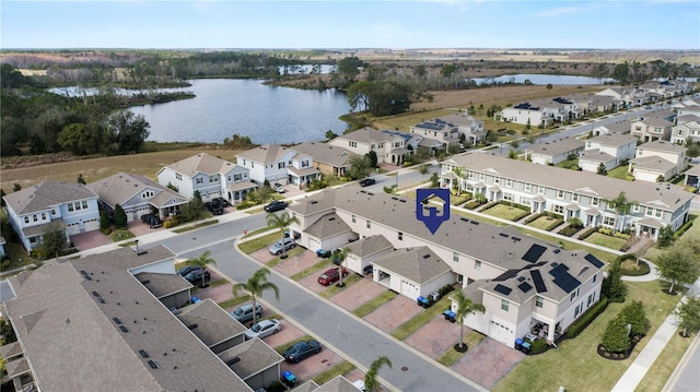 birds eye view of property featuring a water view and a residential view