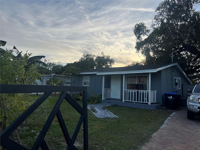 view of front of home featuring a porch and a yard