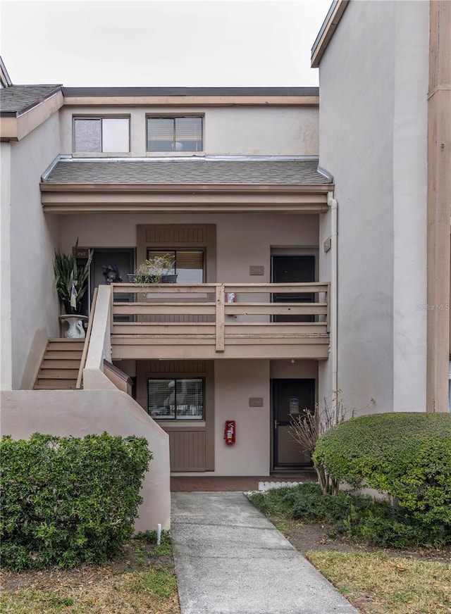 view of exterior entry featuring a balcony