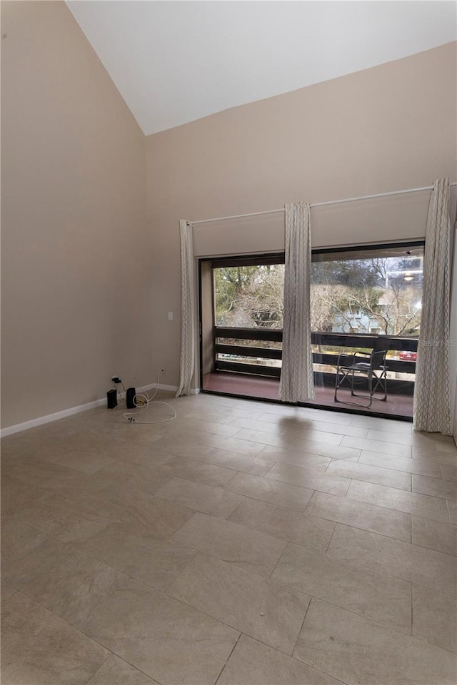 empty room featuring high vaulted ceiling