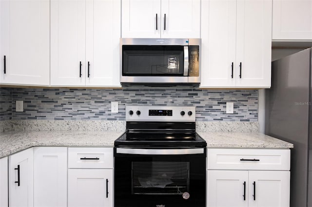 kitchen with white cabinetry, light stone countertops, tasteful backsplash, and stainless steel appliances