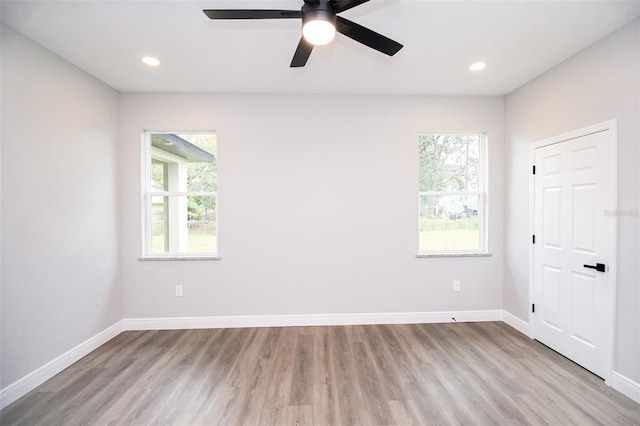 empty room featuring ceiling fan and light hardwood / wood-style floors