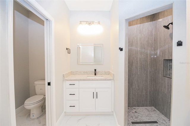 bathroom with a shower, vanity, and toilet