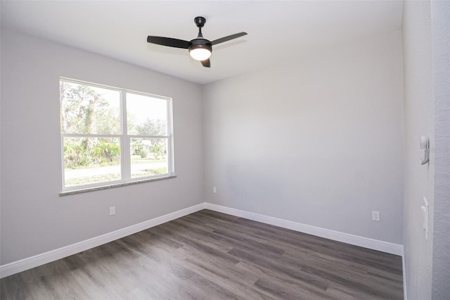 spare room featuring dark hardwood / wood-style floors and ceiling fan