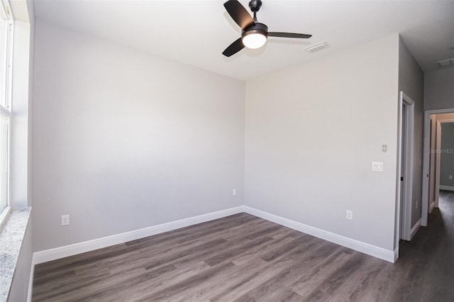 empty room featuring ceiling fan and dark hardwood / wood-style floors