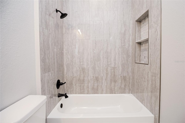 bathroom featuring bathtub / shower combination and toilet