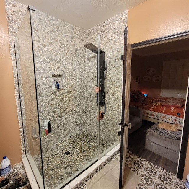 bathroom with a shower with shower door and wood-type flooring