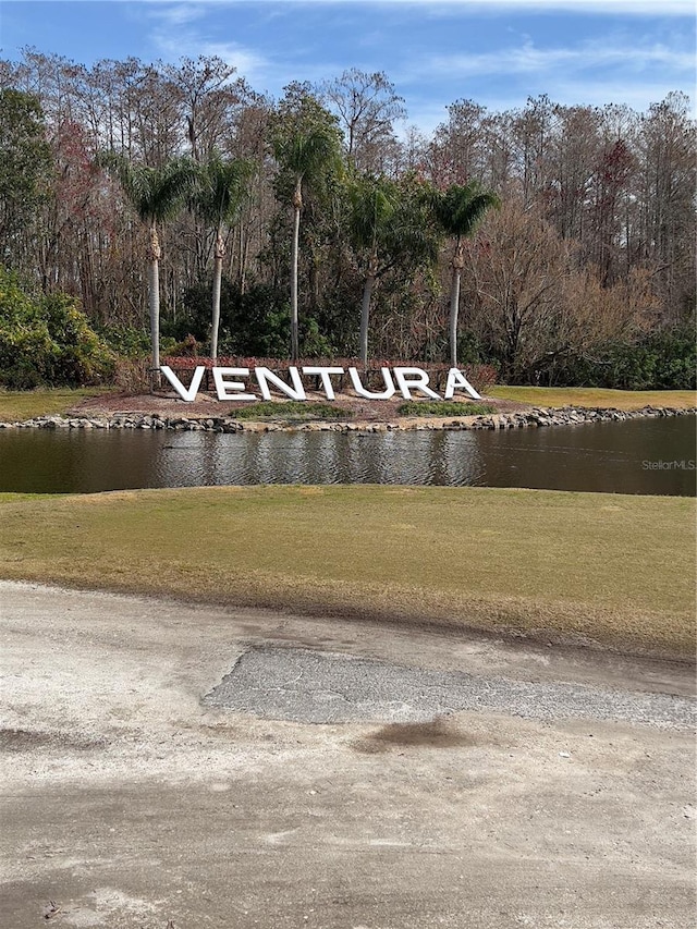 view of home's community featuring a water view and a yard