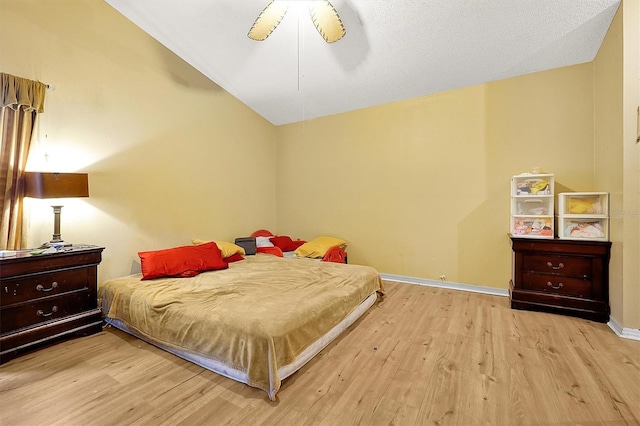 bedroom featuring vaulted ceiling, light wood-type flooring, and ceiling fan