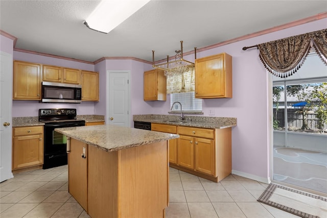 kitchen with plenty of natural light, a center island, sink, and black appliances