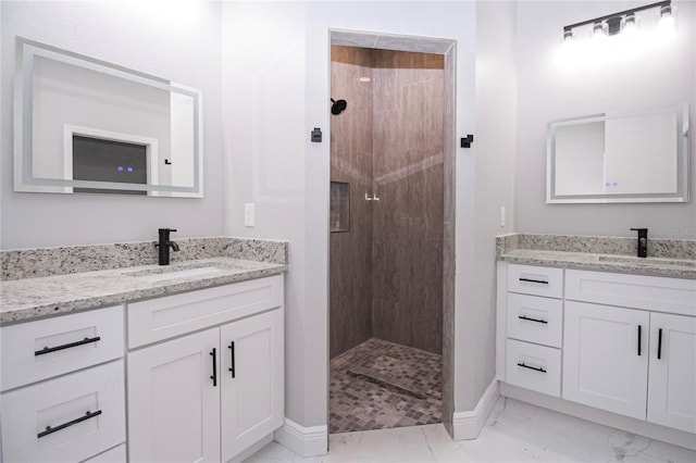 bathroom featuring vanity and tiled shower