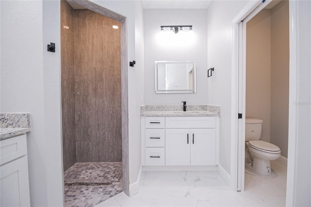 bathroom featuring vanity, walk in shower, and toilet