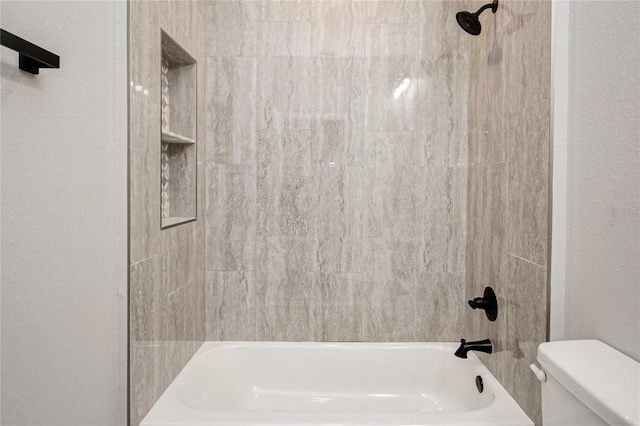 bathroom featuring shower / tub combination and toilet