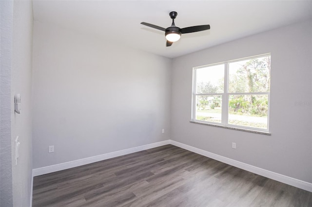 unfurnished room with ceiling fan and dark hardwood / wood-style flooring