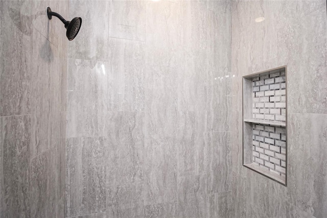 interior details with a tile shower