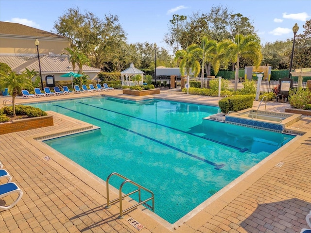 view of pool featuring a gazebo, a hot tub, and a patio