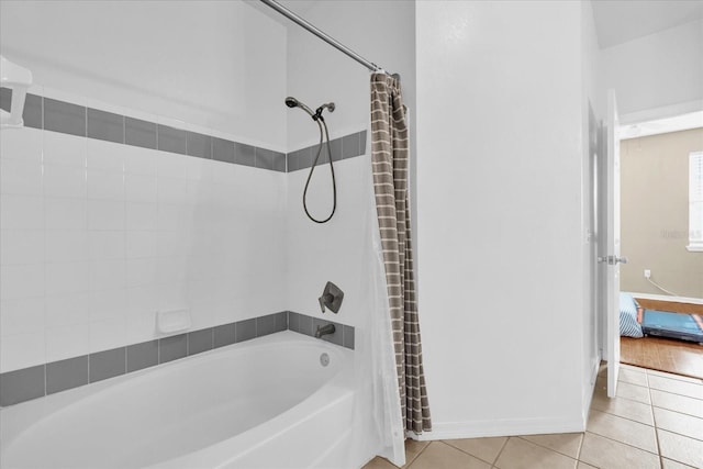 bathroom with shower / tub combo with curtain and tile patterned flooring