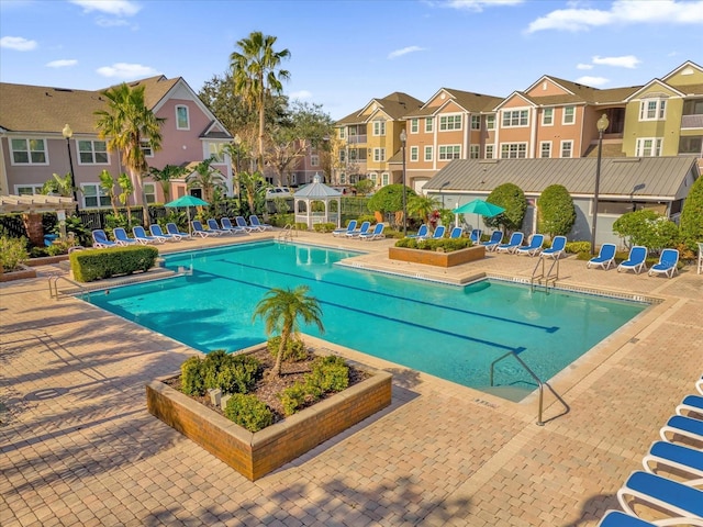 view of swimming pool featuring a gazebo and a patio