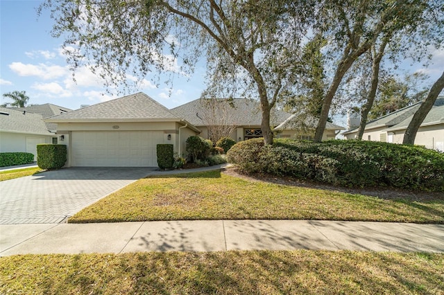 view of front of house featuring a garage and a front yard