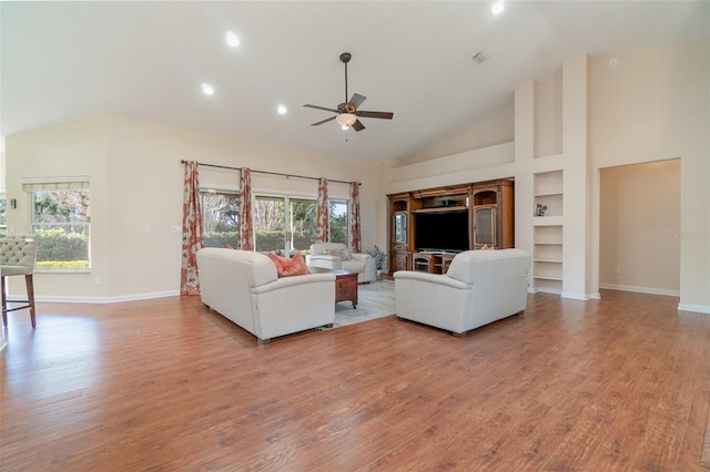 unfurnished living room with plenty of natural light, high vaulted ceiling, and light hardwood / wood-style flooring