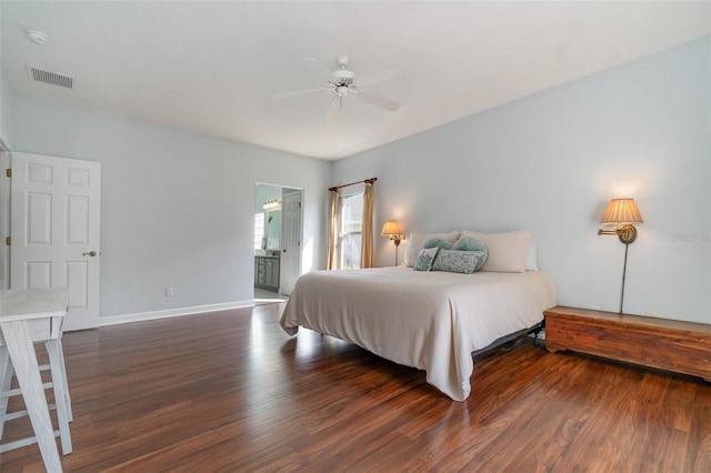 bedroom with ensuite bath, dark hardwood / wood-style floors, and ceiling fan