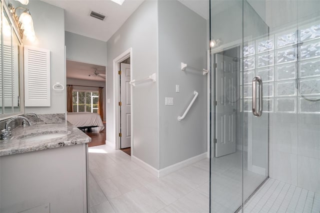 bathroom featuring ceiling fan, tile patterned floors, vanity, and an enclosed shower