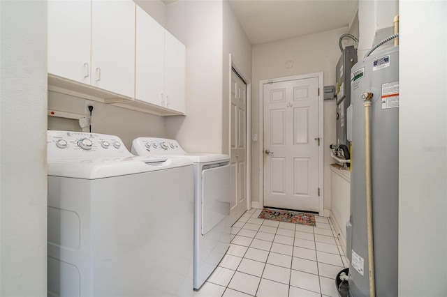 clothes washing area featuring cabinets, light tile patterned floors, water heater, and washing machine and clothes dryer