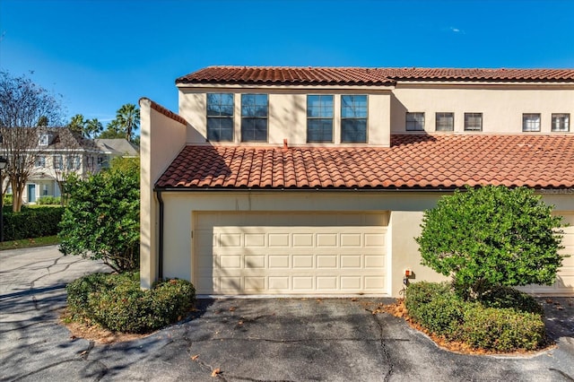 mediterranean / spanish-style house with a garage