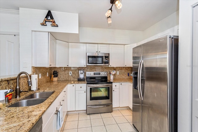 kitchen featuring white cabinetry, sink, light stone countertops, and appliances with stainless steel finishes