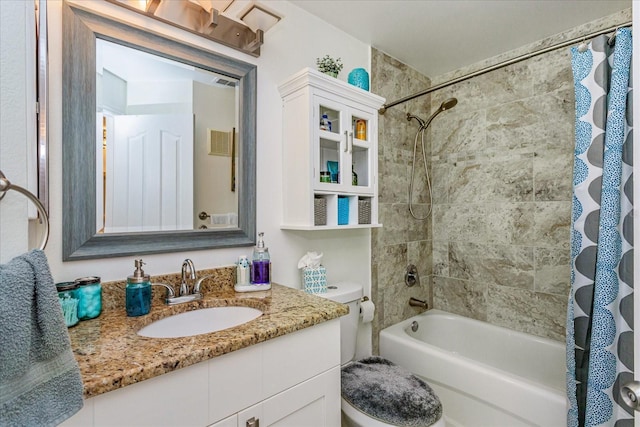 full bathroom featuring vanity, toilet, and shower / tub combo