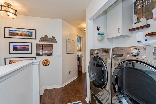 clothes washing area featuring cabinets, washer and dryer, and dark wood-type flooring