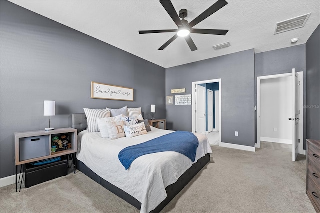 carpeted bedroom with a textured ceiling and ceiling fan