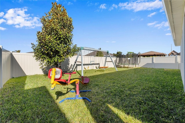 view of yard featuring a trampoline and a playground