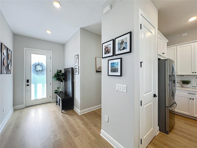 entrance foyer with a wealth of natural light and light wood-type flooring