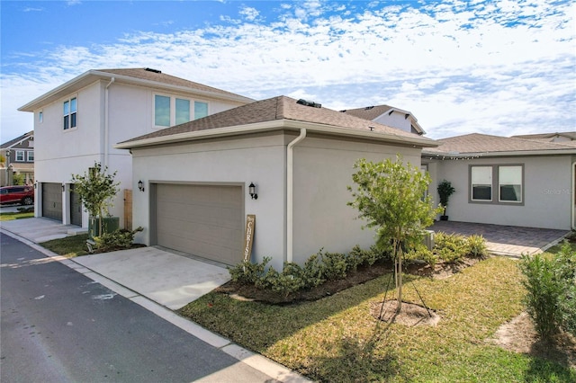 view of property exterior featuring a garage and a yard