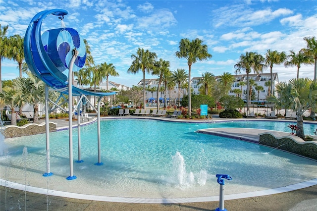 view of swimming pool with pool water feature