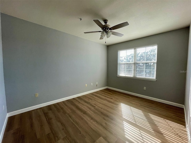 empty room featuring hardwood / wood-style flooring and ceiling fan