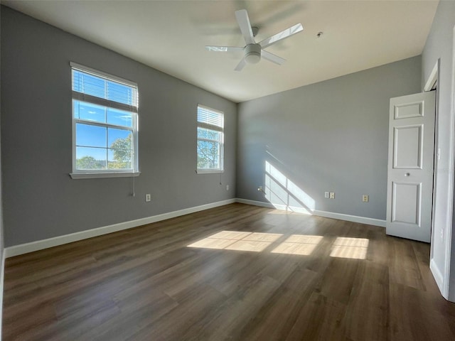 unfurnished bedroom with ceiling fan and dark hardwood / wood-style floors