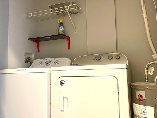 washroom featuring washing machine and clothes dryer and water heater