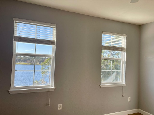 spare room featuring a water view