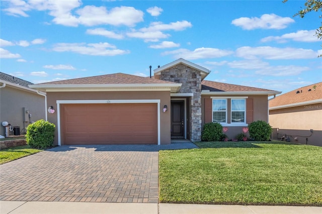 view of front of home featuring a garage and a front lawn