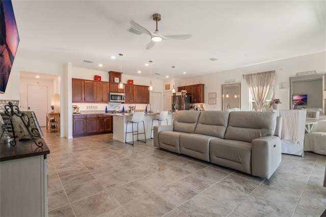 living room featuring sink and ceiling fan